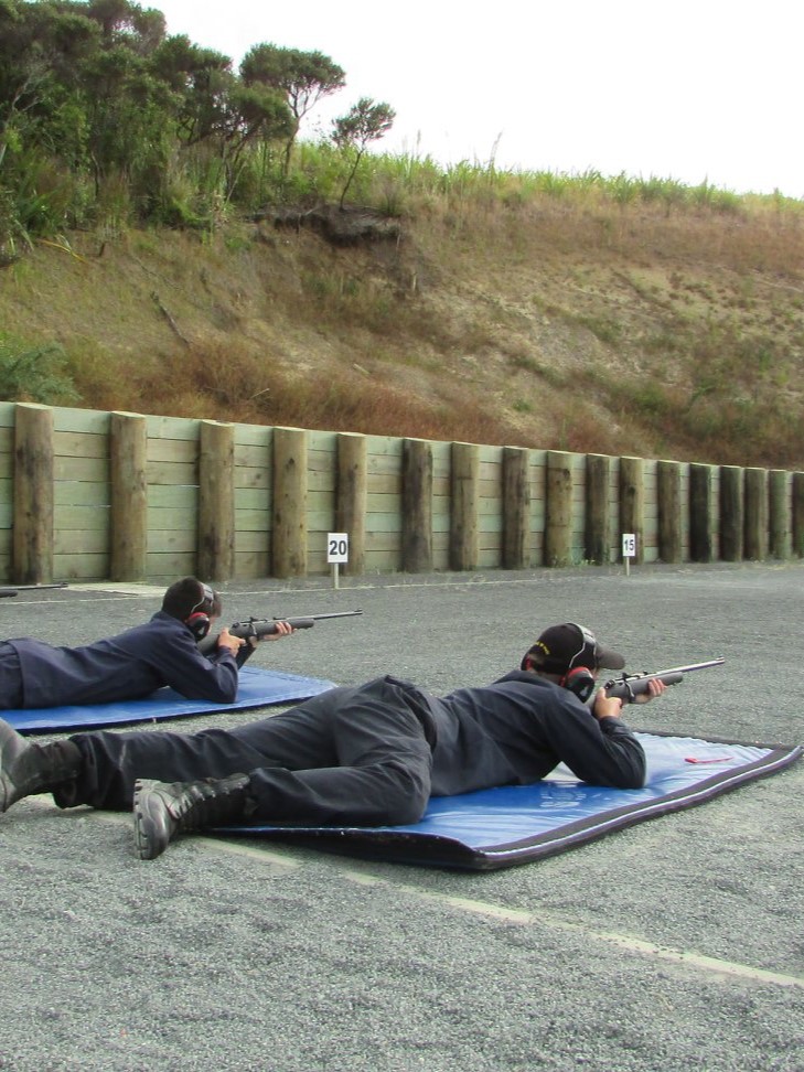 Cadet conducting firearm training and shooting on a controlled range.